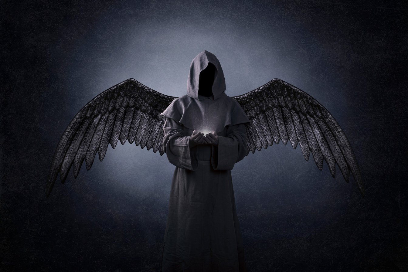 Angel of death with soul in hands in the dark